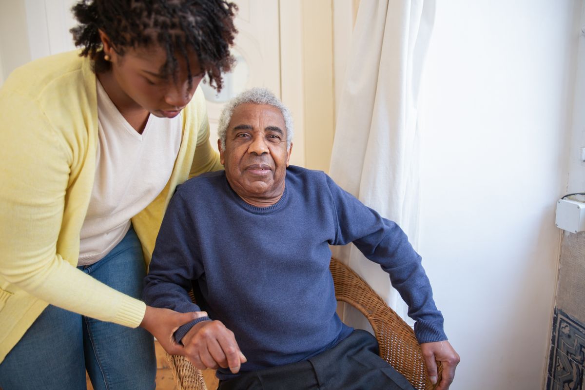 Care worker providing attentive support to an elderly resident