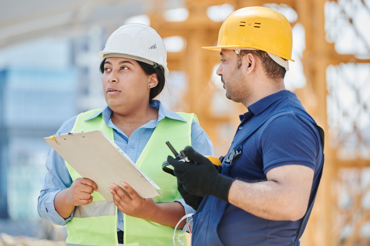 Construction workers in discussion on a UK building site
