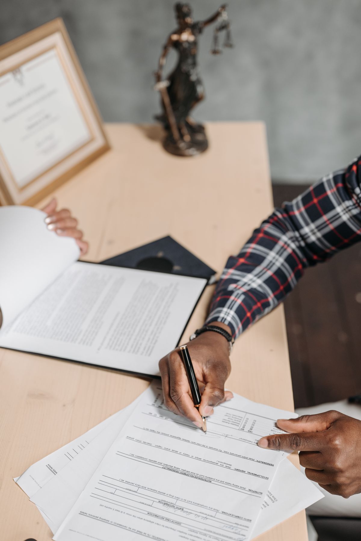 Contract documents and a pen on a desk — the starting point of every social value bid